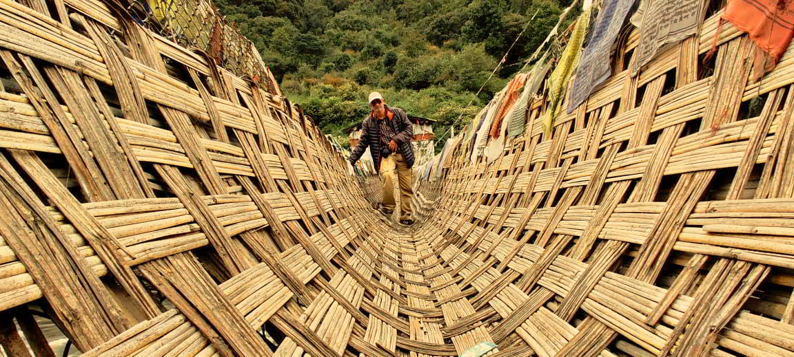 Chakzam bridge ancient engineering marvel in Tawang arunachal pradesh. The bridge is stayed using iron chains and covered by mat made of bamboo and cane. Initially vasu struggled to walk